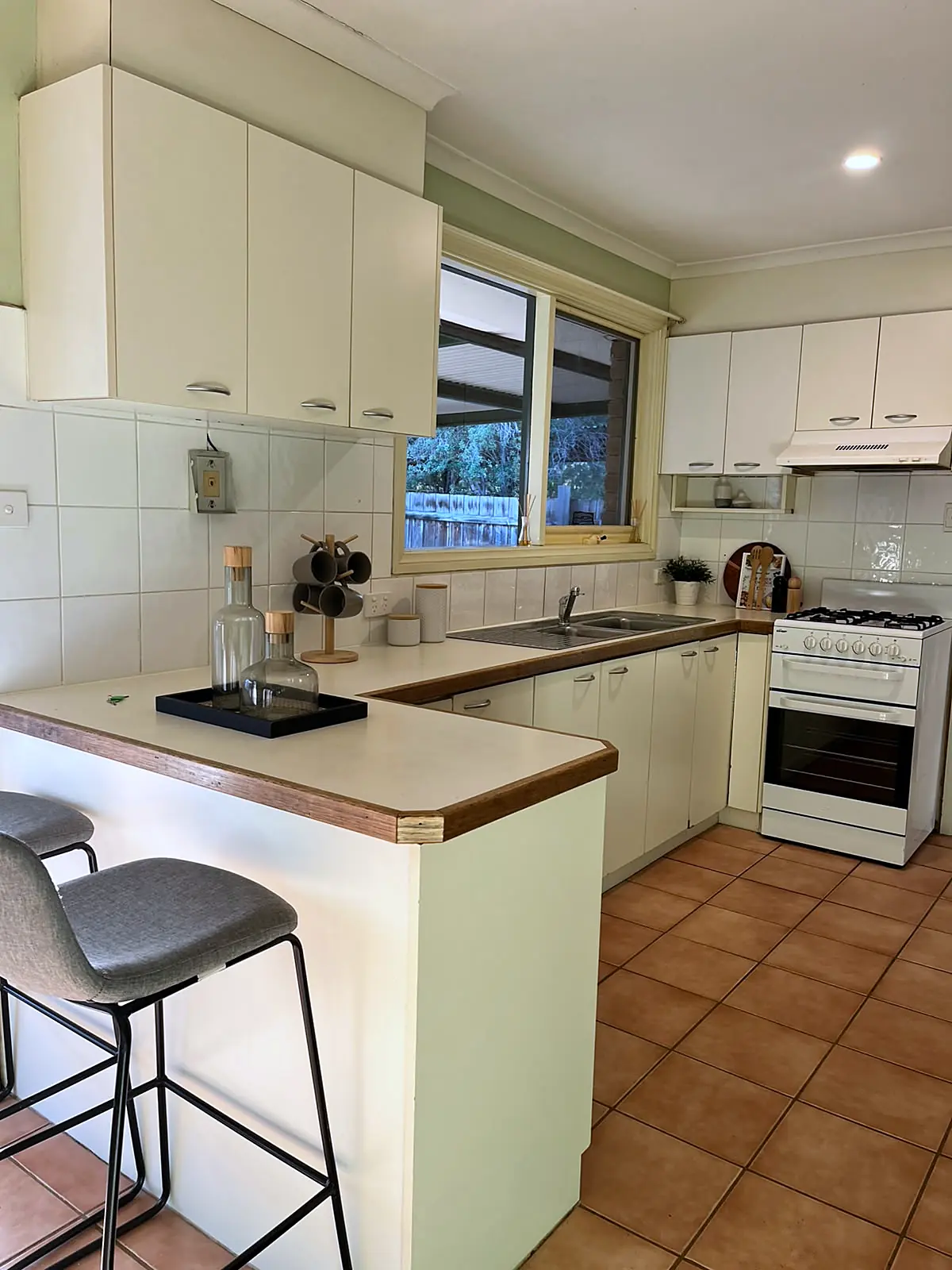 Cream kitchen with breakfast bar styled for sale in a Melton home