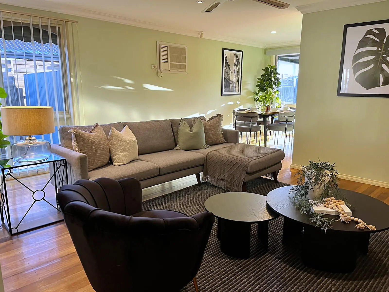 Lounge styled with charcoal armchairs and black coffee tables in a Melton home