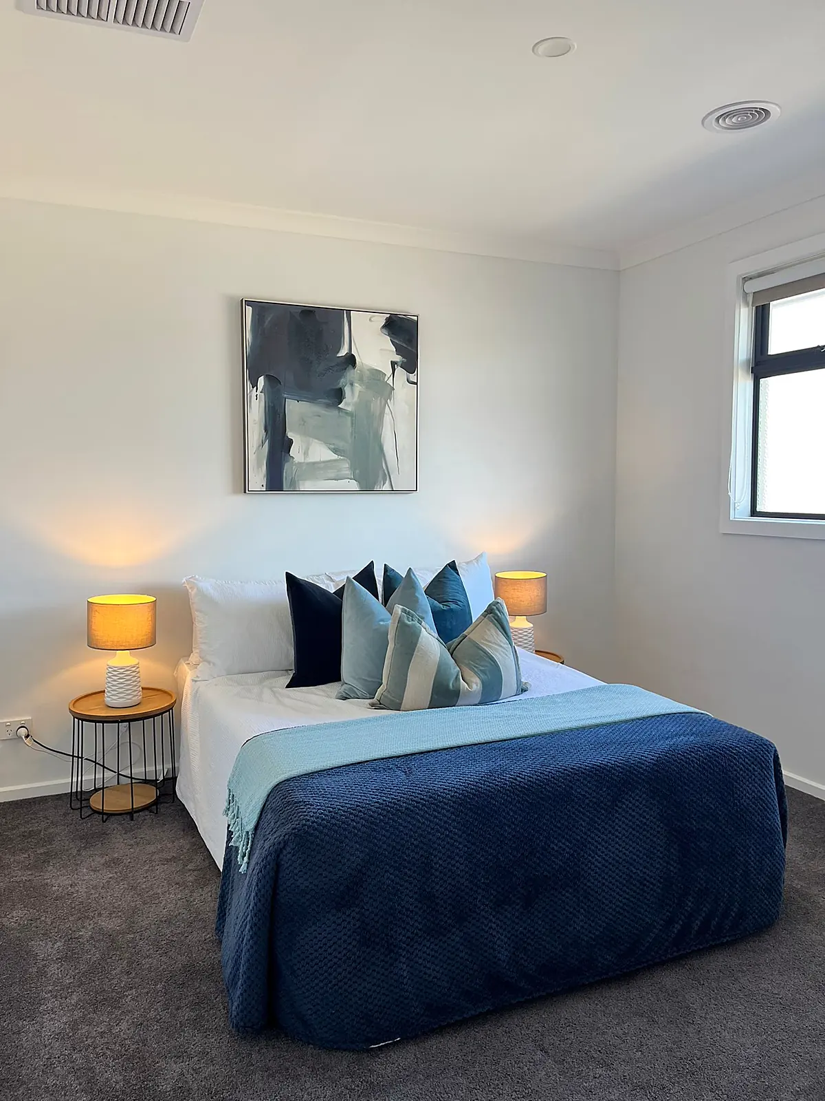 Bedroom styled with navy and teal linen in a Mickleham home