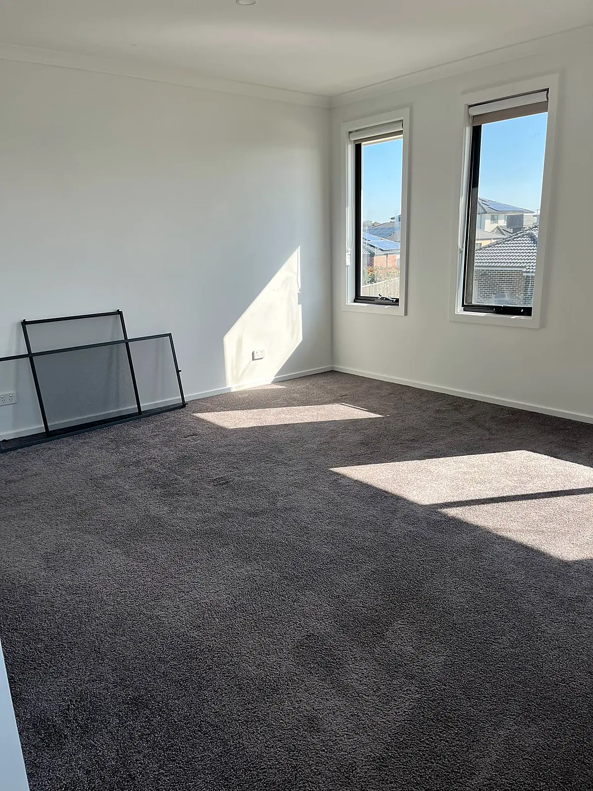 Empty carpeted bedroom before staging in a Mickleham home
