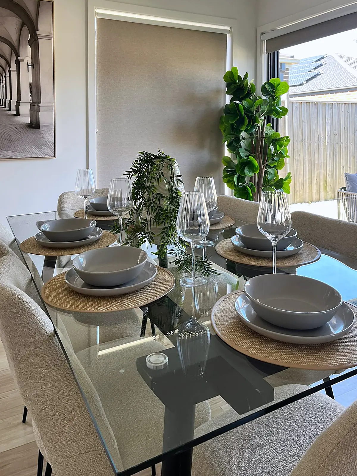 Glass dining table set for six in a staged Mickleham home