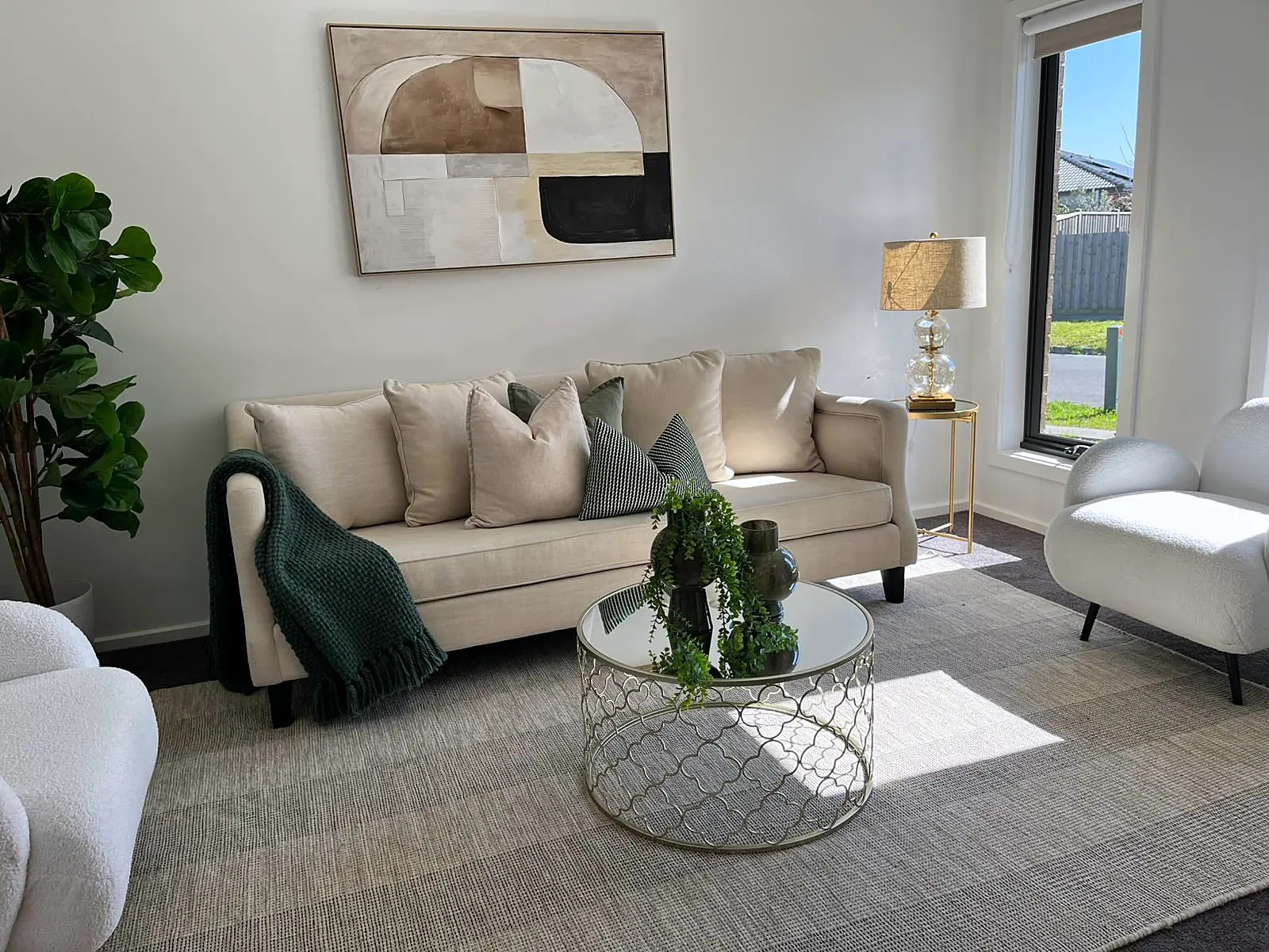 Sitting area styled with cream sofa and glass coffee table in a Mickleham home