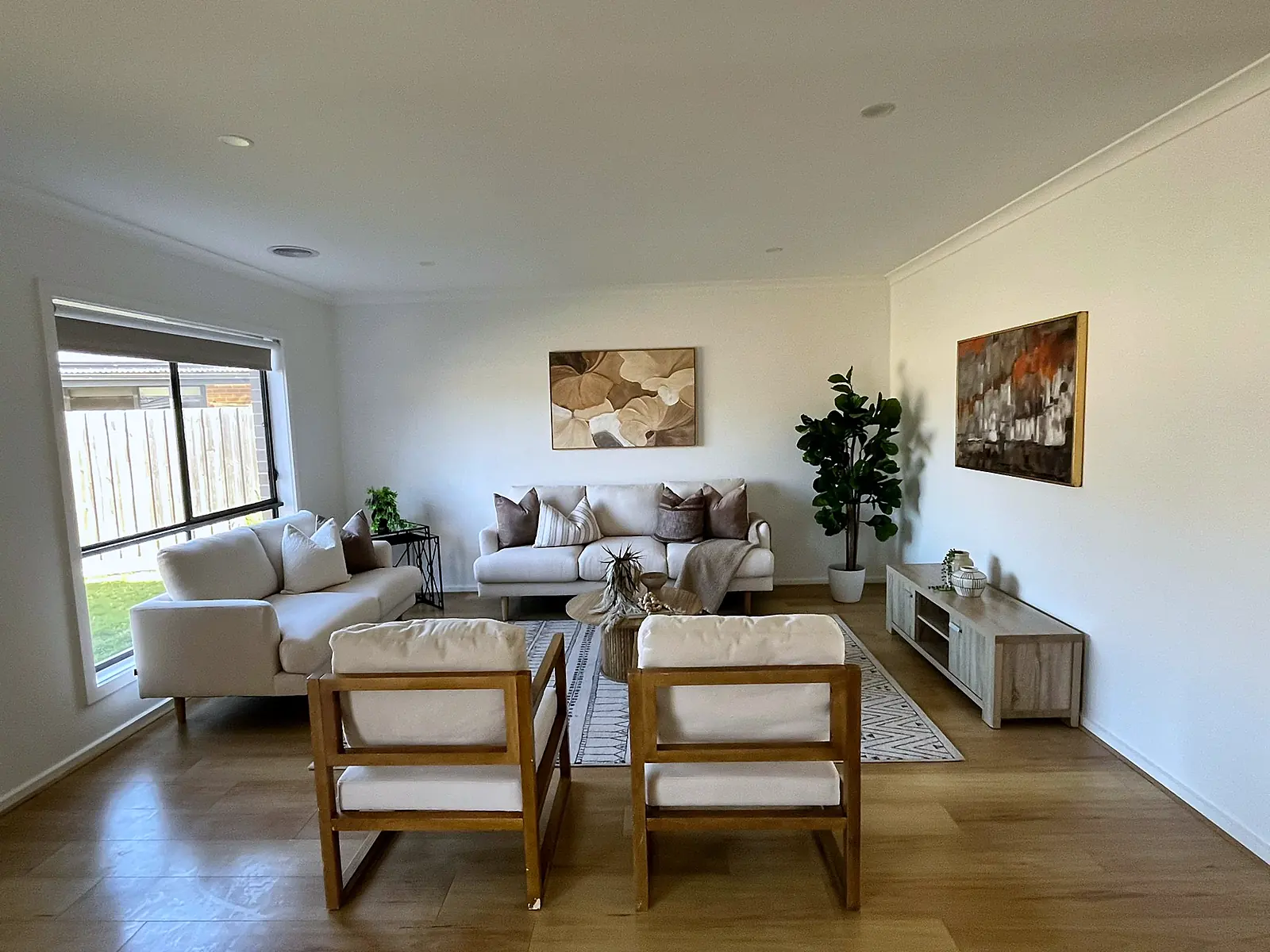 Large living room with armchairs by the sliding door in a staged Mickleham home