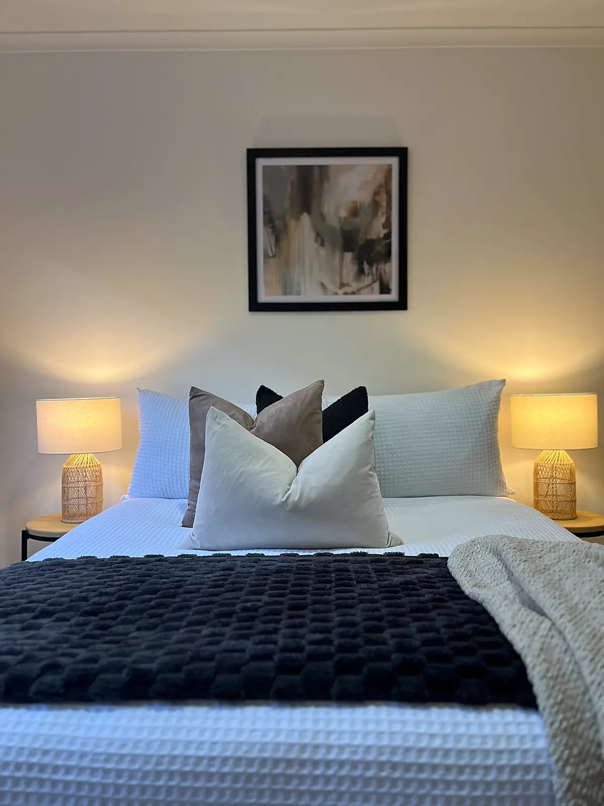 Bedroom styled with charcoal throw and lamps in a Mill Park home