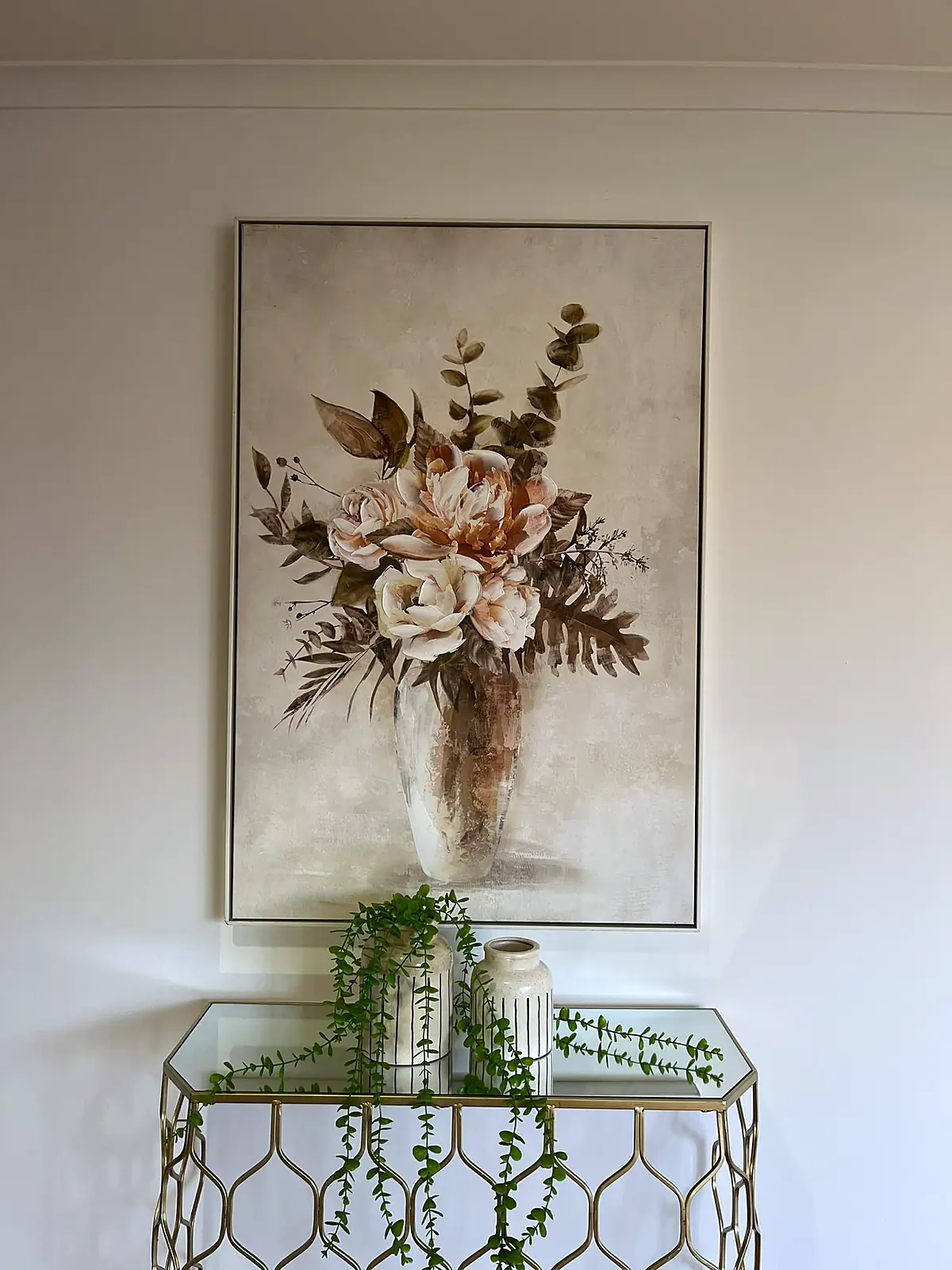 Entry styled with console table and floral artwork in a Mill Park home