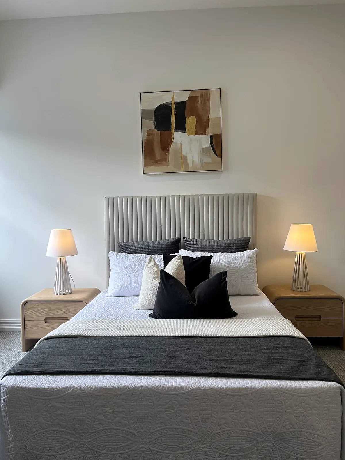 Main bedroom staged with ribbed bedhead and timber bedside tables in an Oak Park home