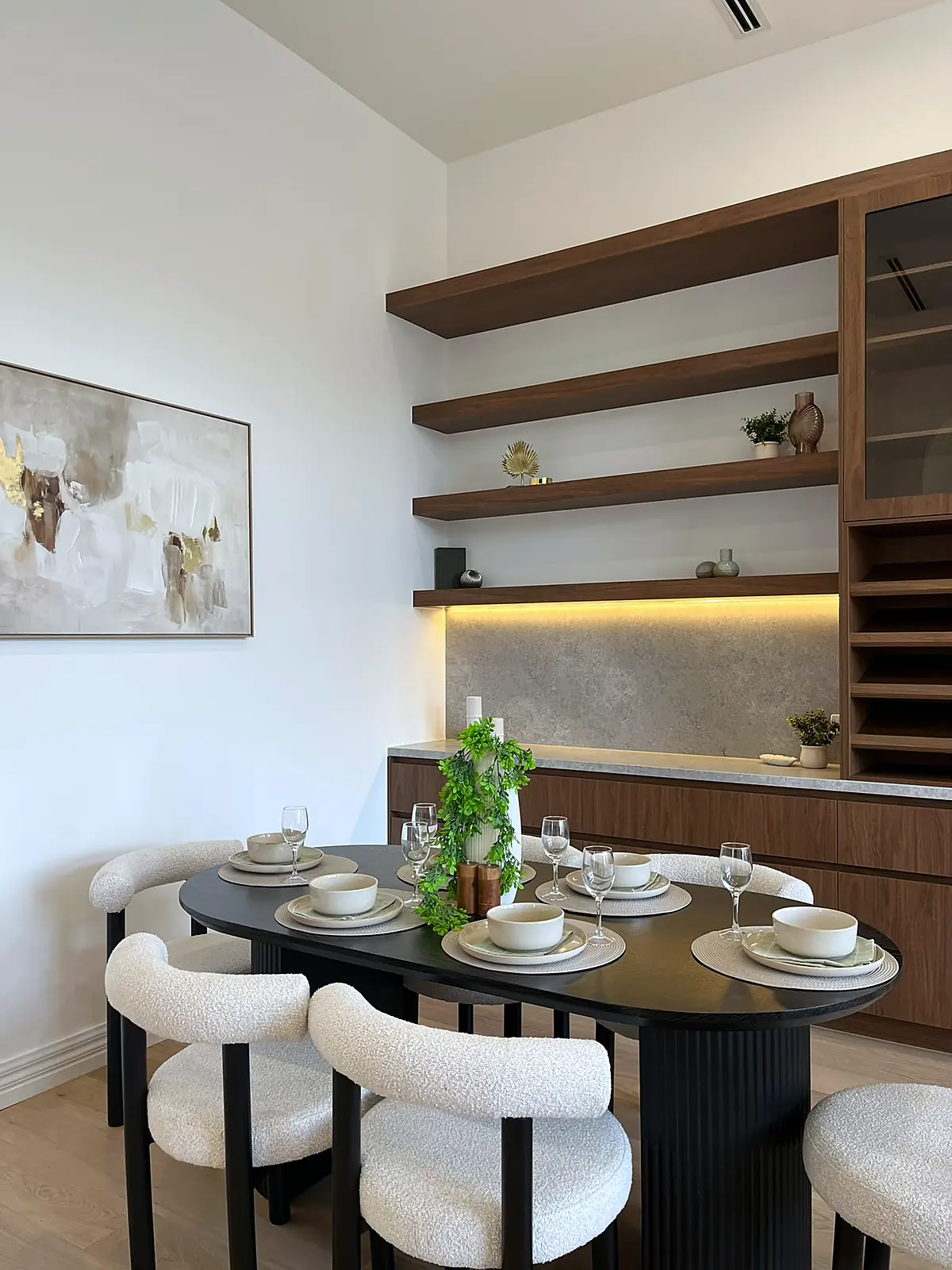 Oval dining table with boucle chairs in a staged Oak Park home