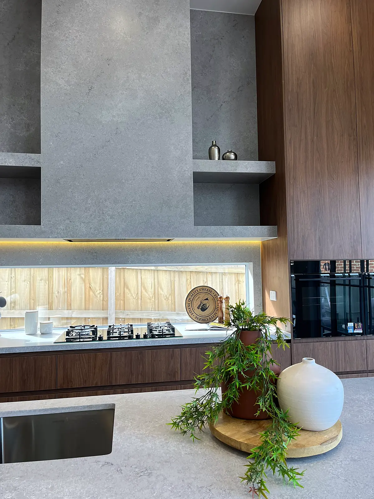 Kitchen bench styled with greenery and ceramics in an Oak Park home