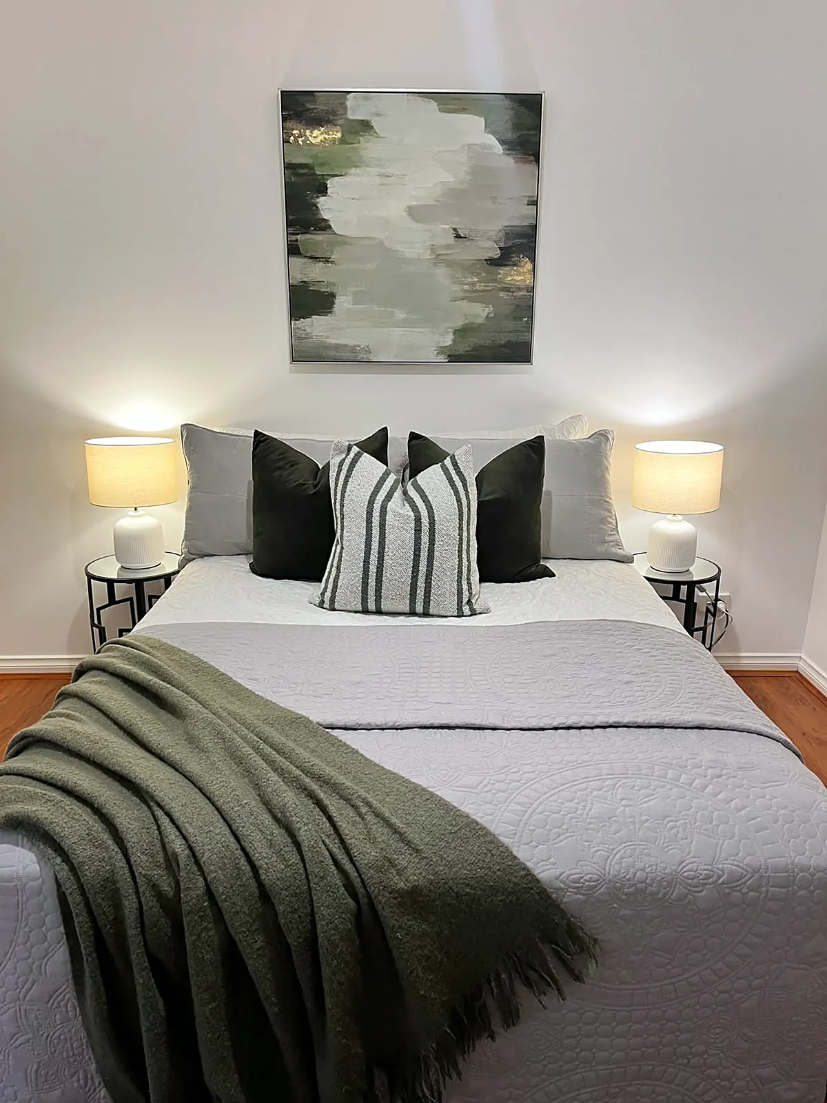 Bedroom styled with green throw and artwork in a Point Cook home