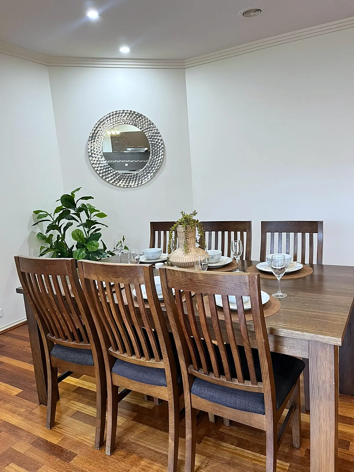 Dining room staged with timber table for six in a Roxburgh Park home