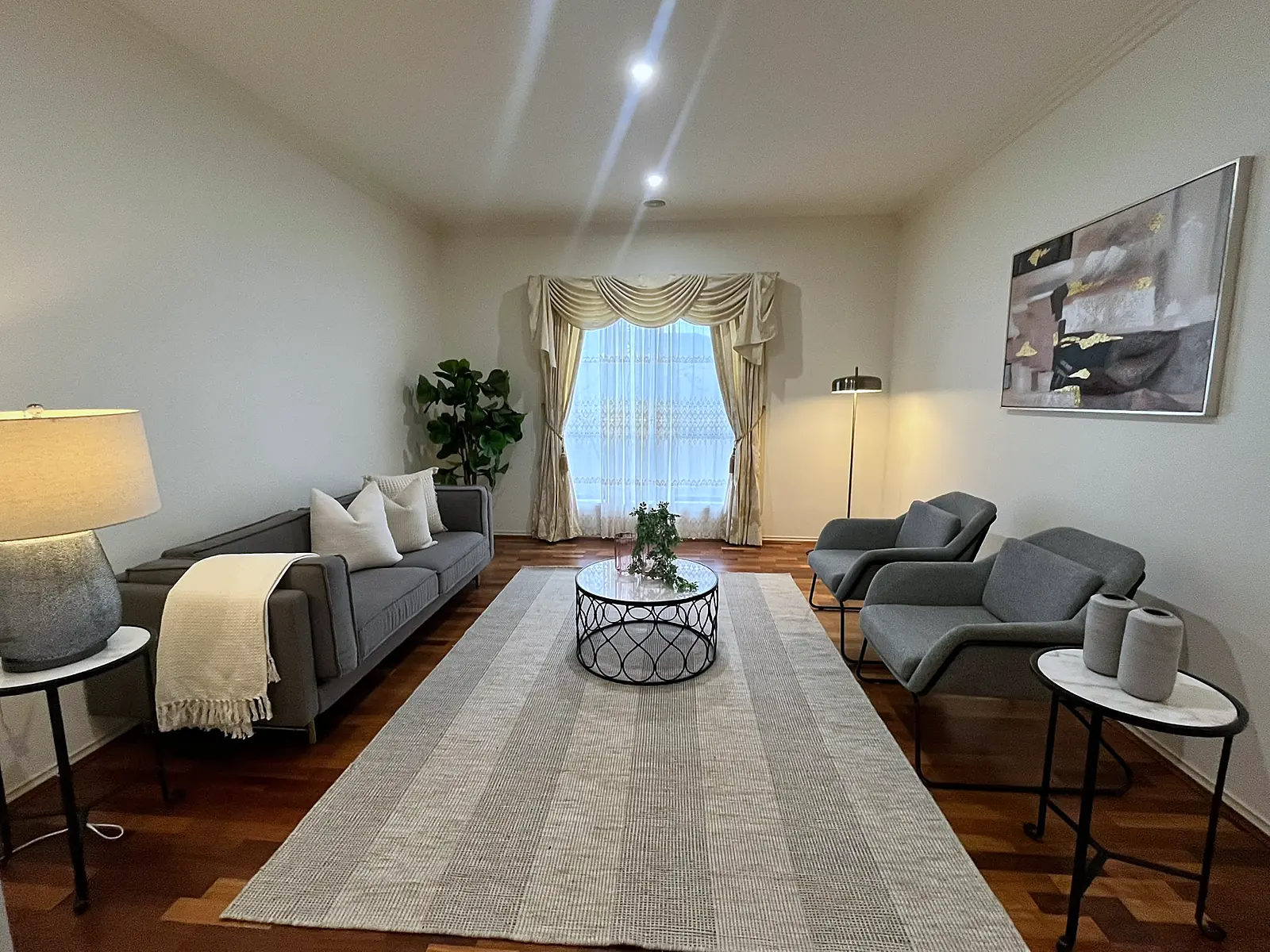 Formal living room staged with sofa, armchairs and rug in Roxburgh Park