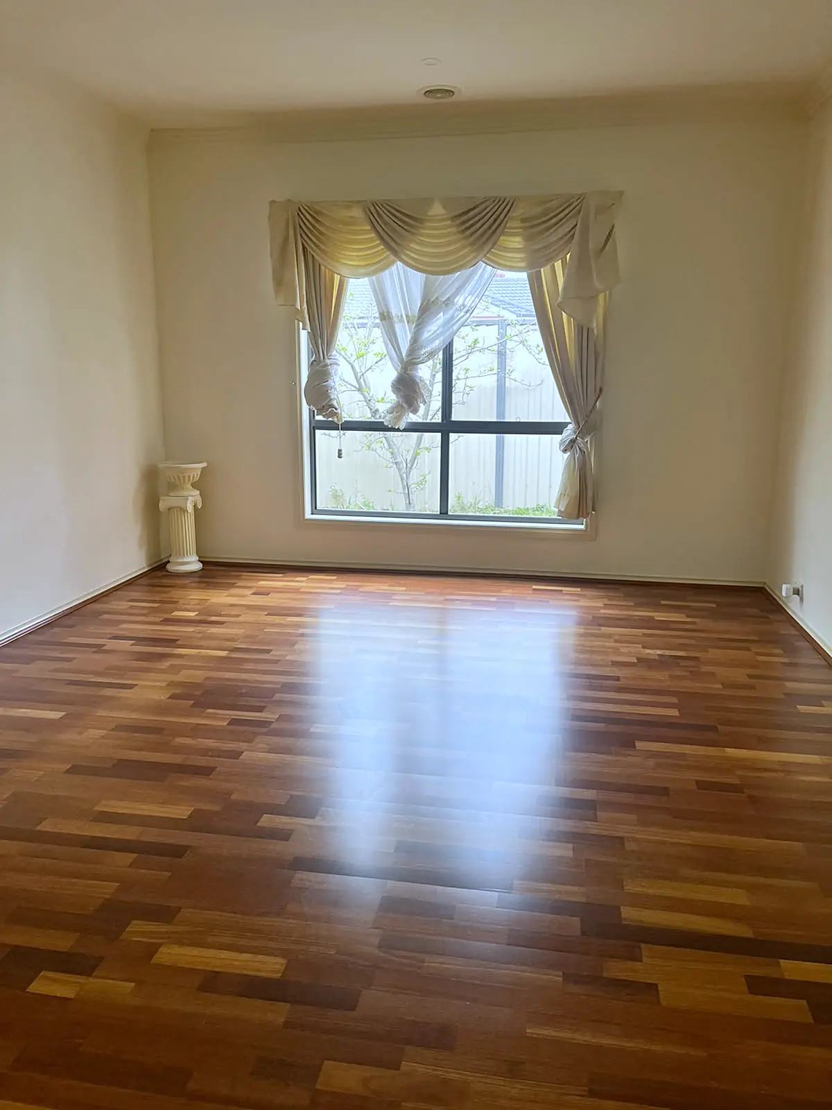 Empty formal lounge with timber floor before staging in a Roxburgh Park home