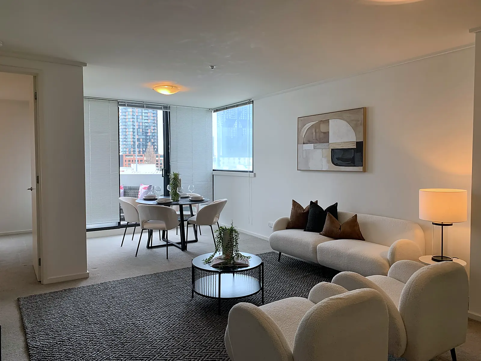 Open-plan apartment living area with city views staged in Southbank