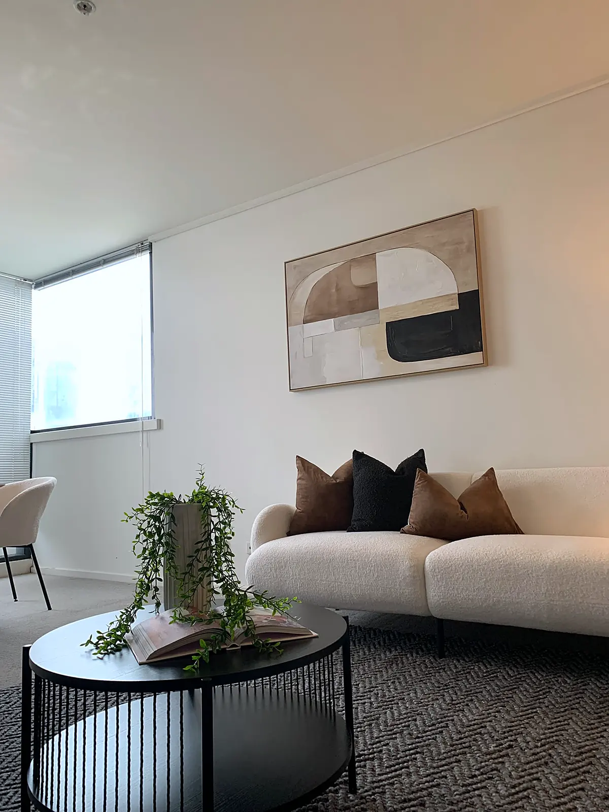 Boucle sofa and round coffee table in a staged Southbank apartment