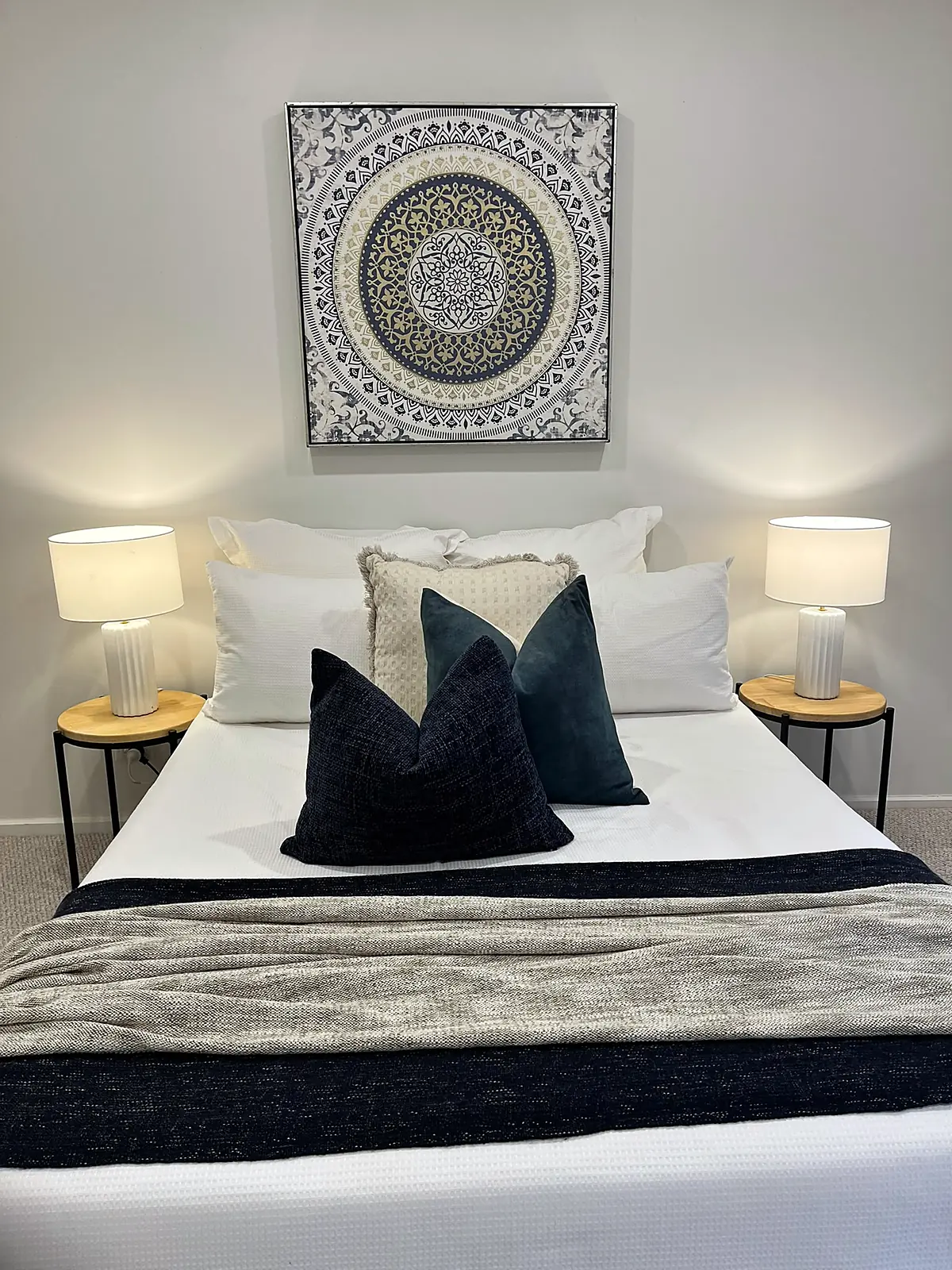 Bedroom styled with navy cushions and artwork in a St Albans home