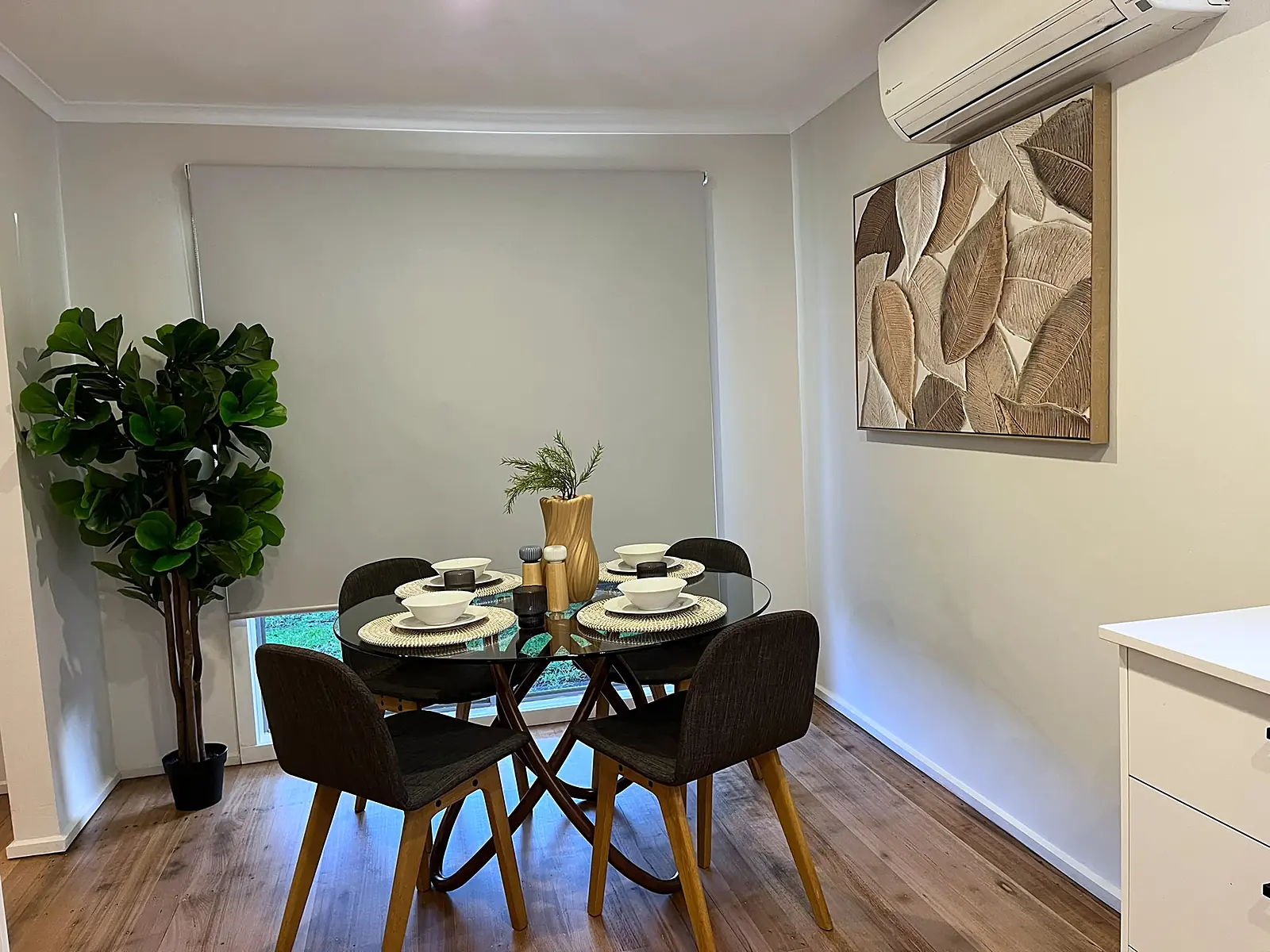 Round dining table with artwork in a staged St Albans home