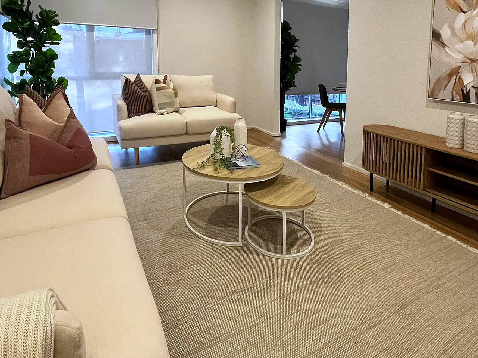 Lounge styled with round coffee tables and timber sideboard in a St Albans home