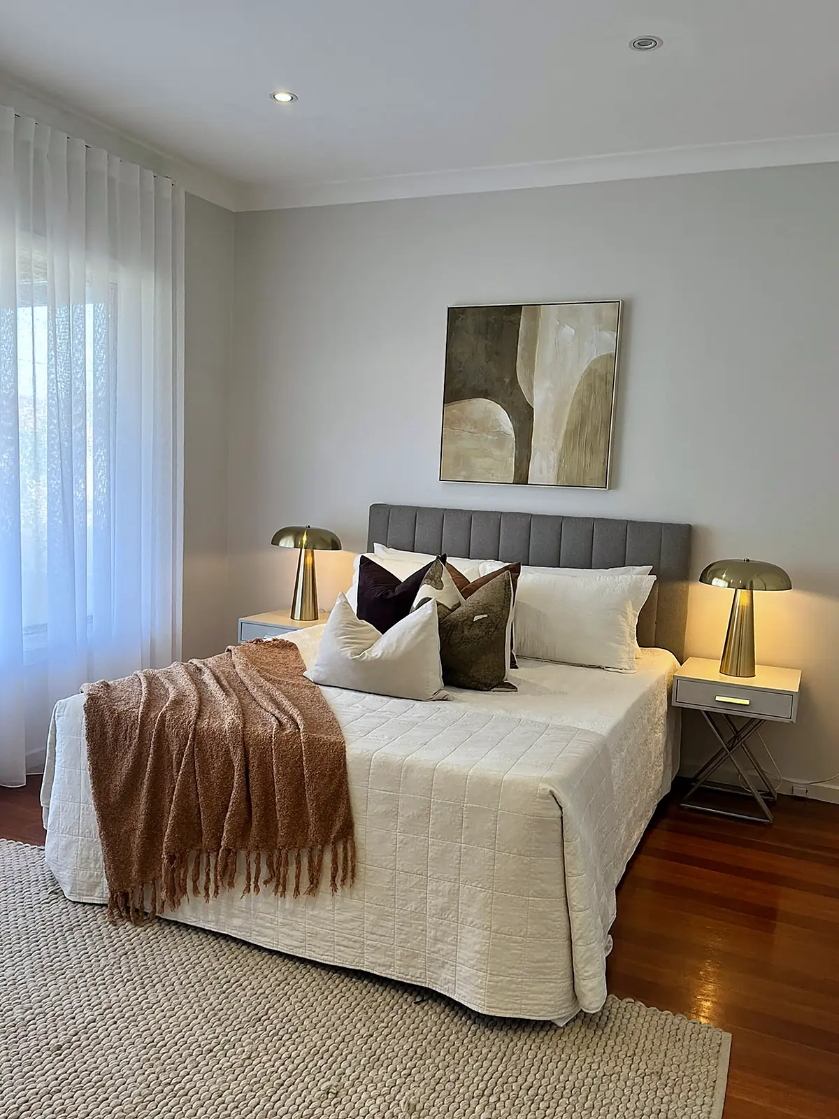 Bedroom styled with white linen and artwork in a Sunshine home