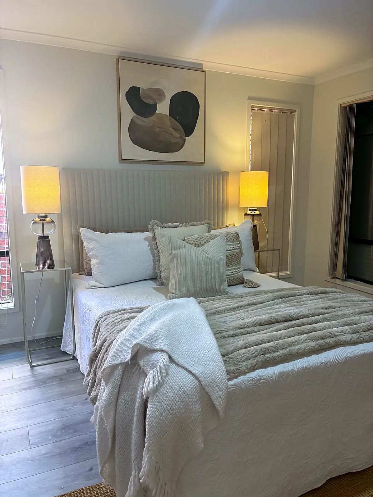 Bedroom staged with sage cushions and upholstered bedhead in Tarneit
