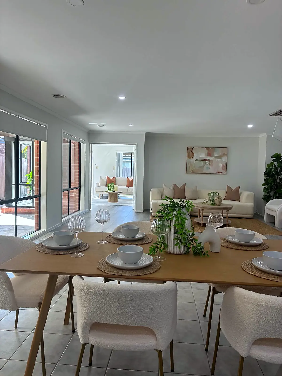 Dining area staged with timber table and boucle chairs in a Tarneit home