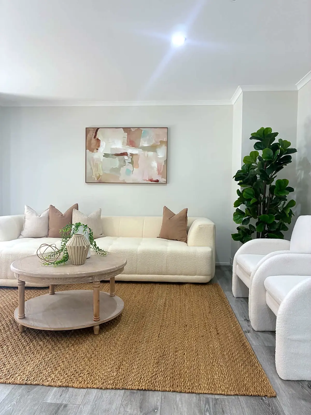 Living room styled with boucle sofa and jute rug in a Tarneit home