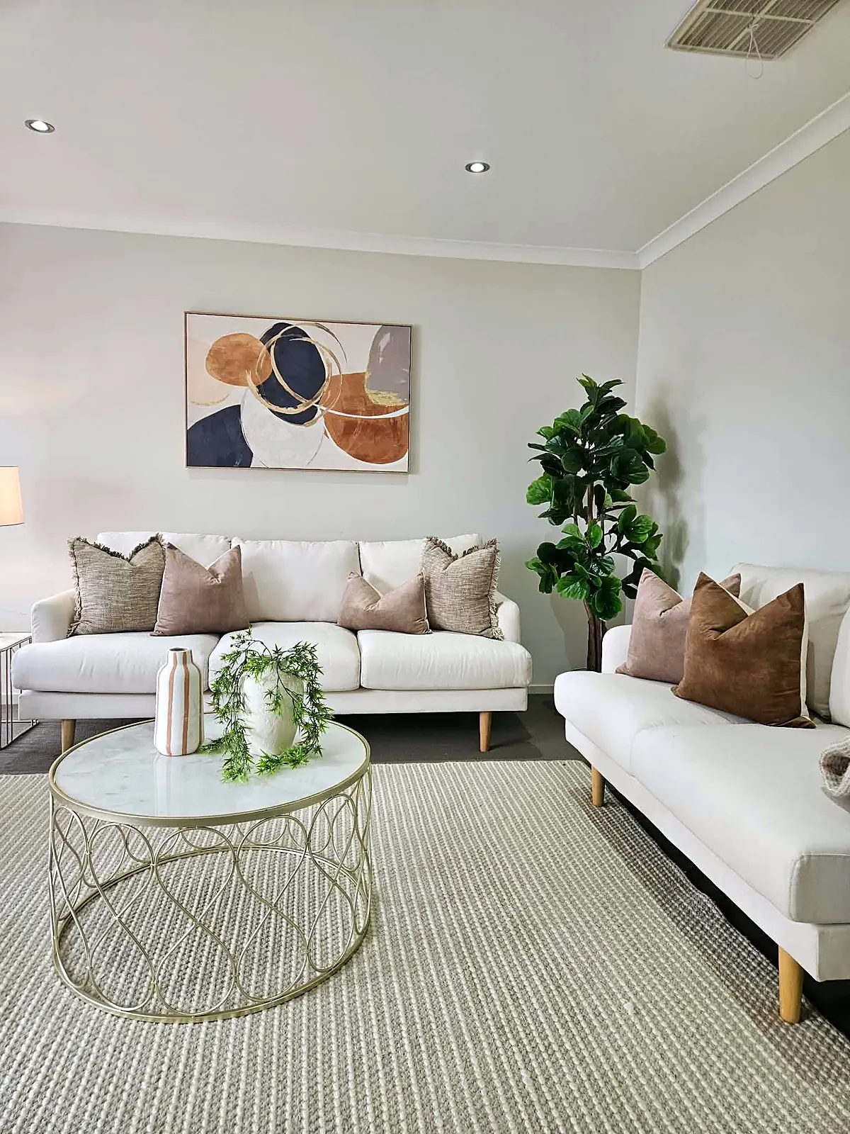 Formal lounge staged with two cream sofas and marble coffee table in a Taylors Hill home