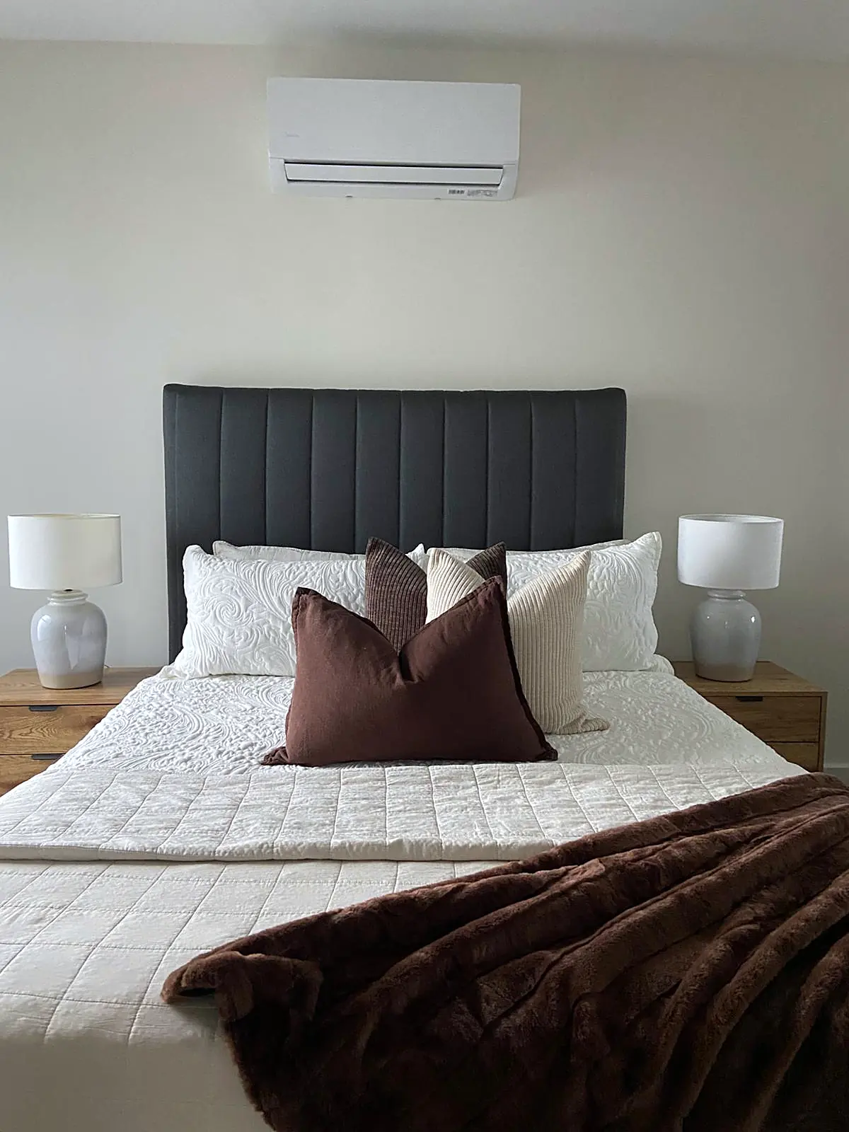Main bedroom staged with charcoal bedhead and chocolate throw in a Thomastown townhouse