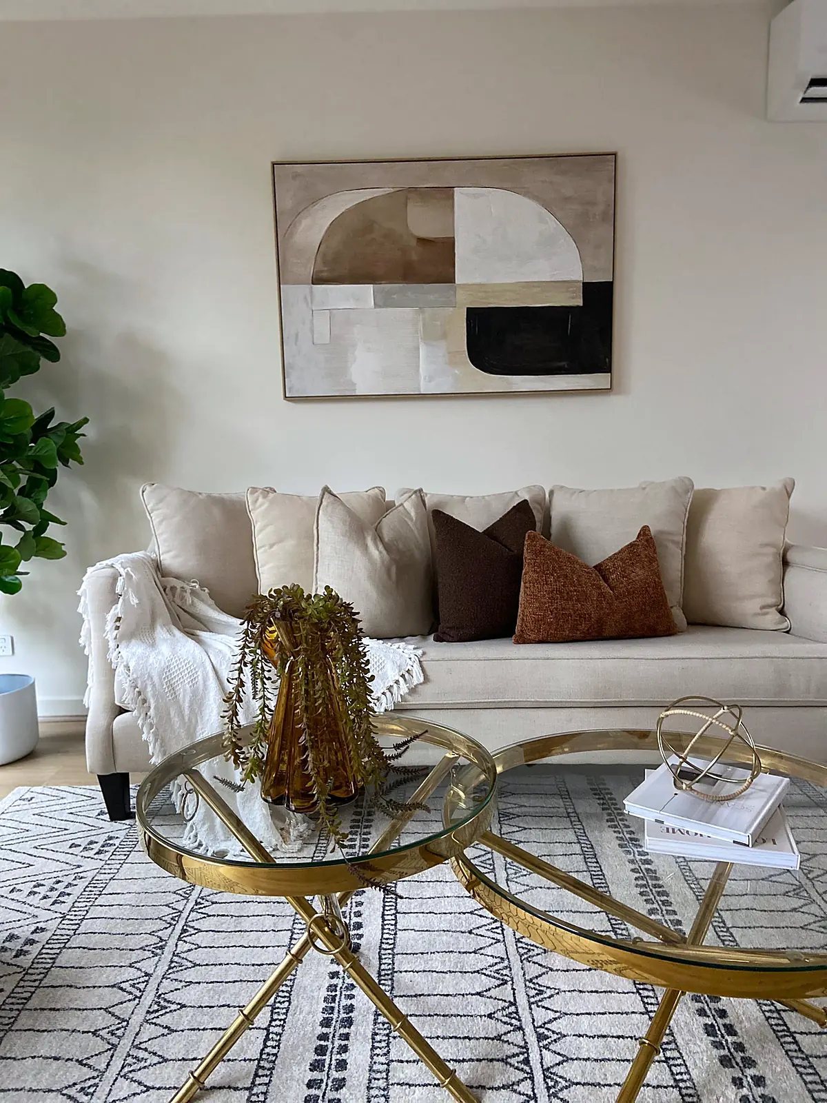 Living room staged with cream sofa and glass coffee tables in a new Thomastown townhouse