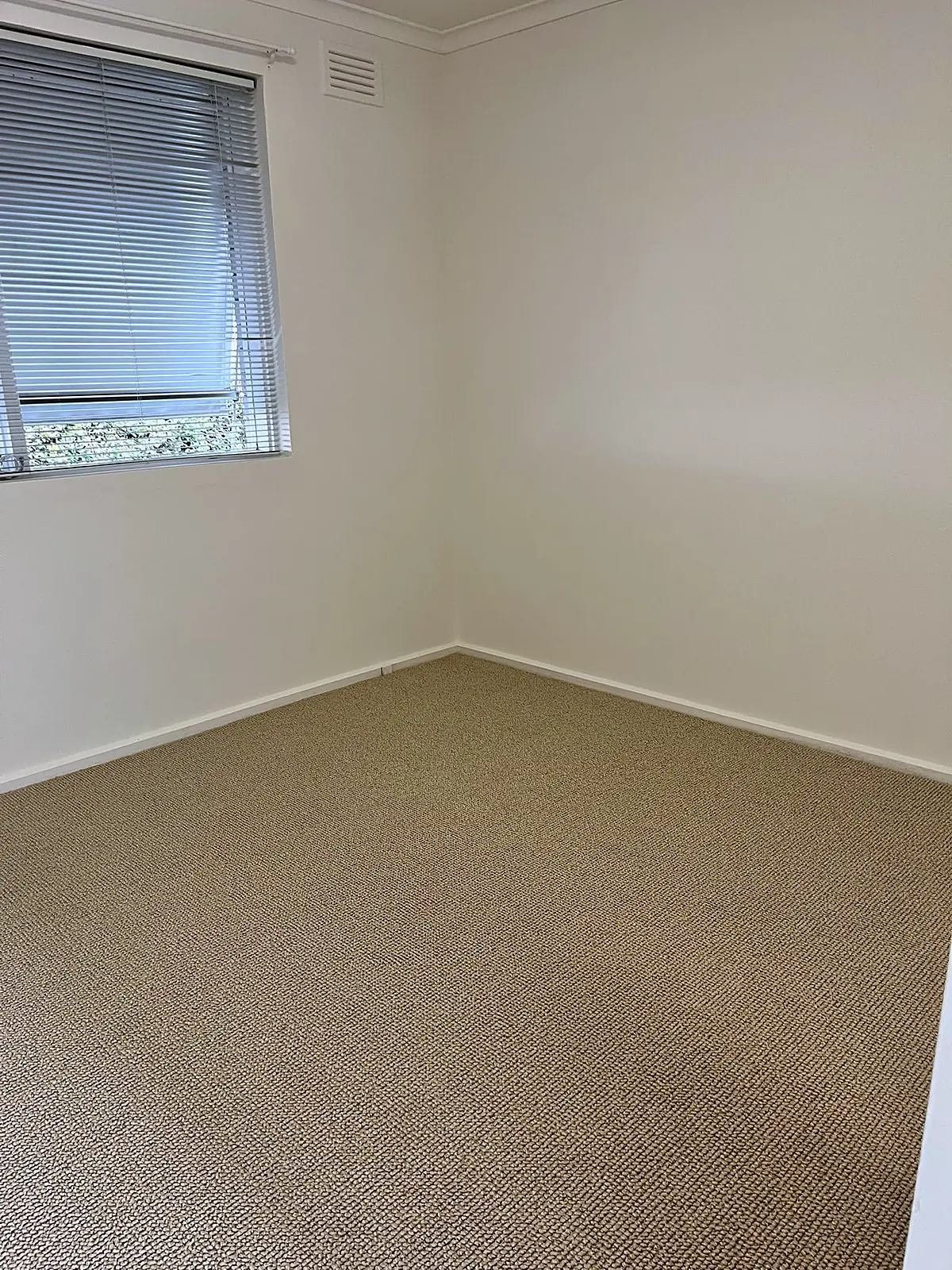Empty bedroom with new carpet before staging in a Thornbury unit