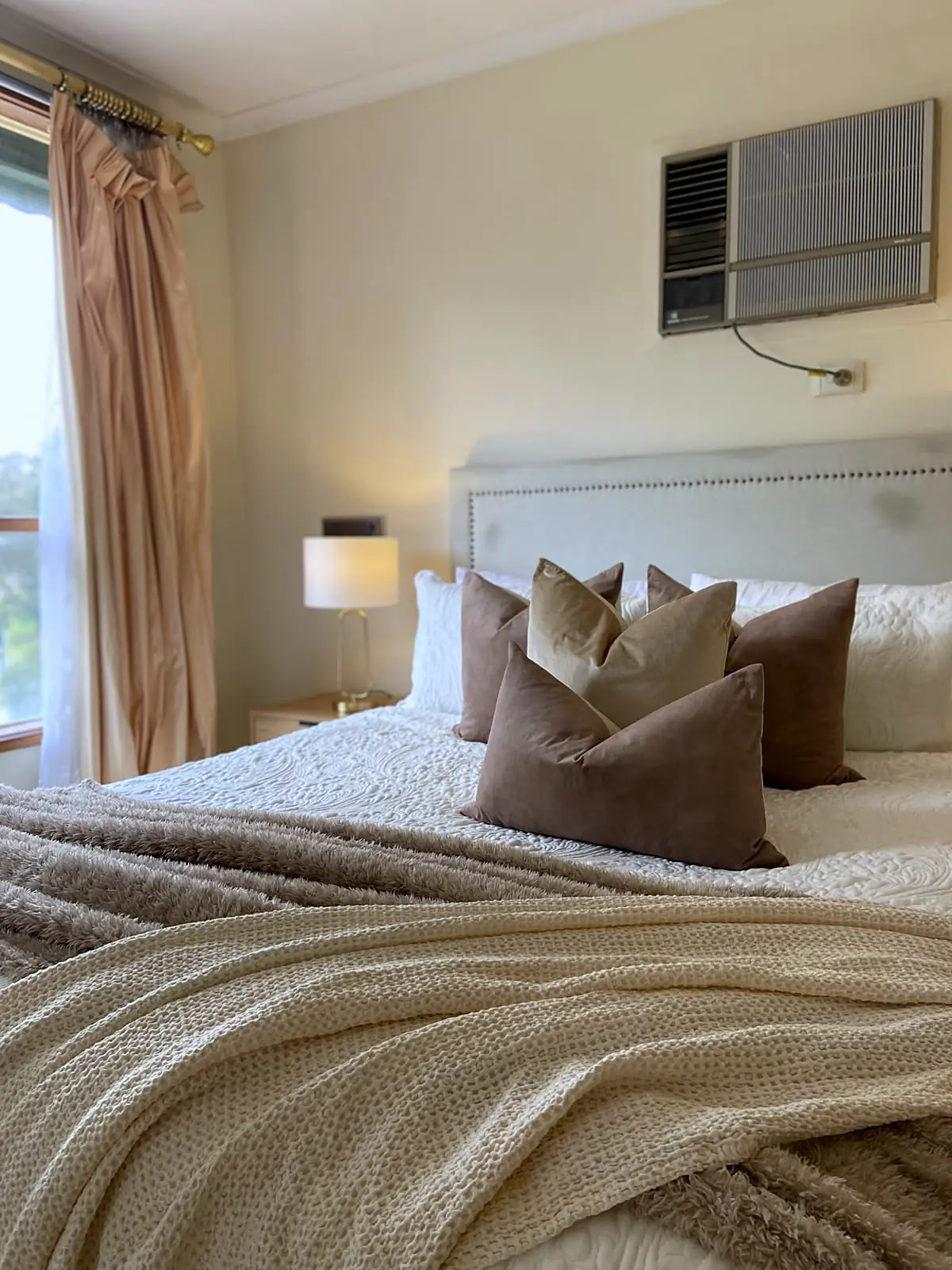 Master bedroom styled with layered neutral linen in a Watsonia home