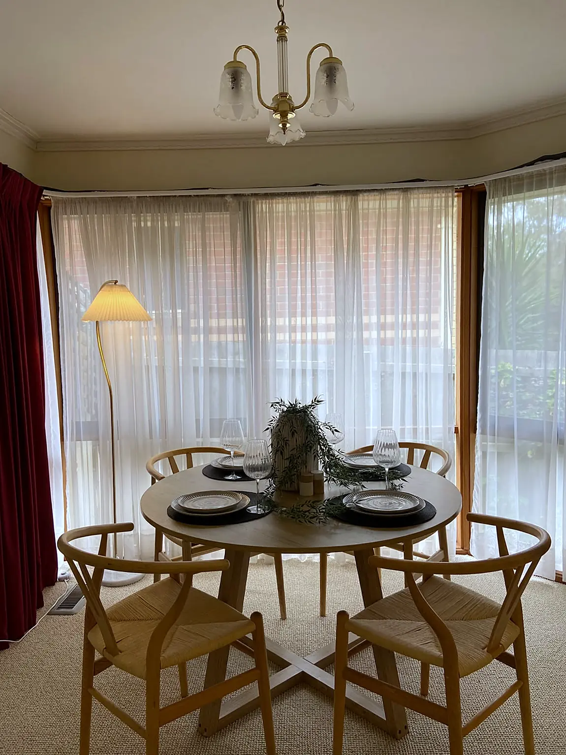 Dining room in a bay window staged with round table in a Watsonia home