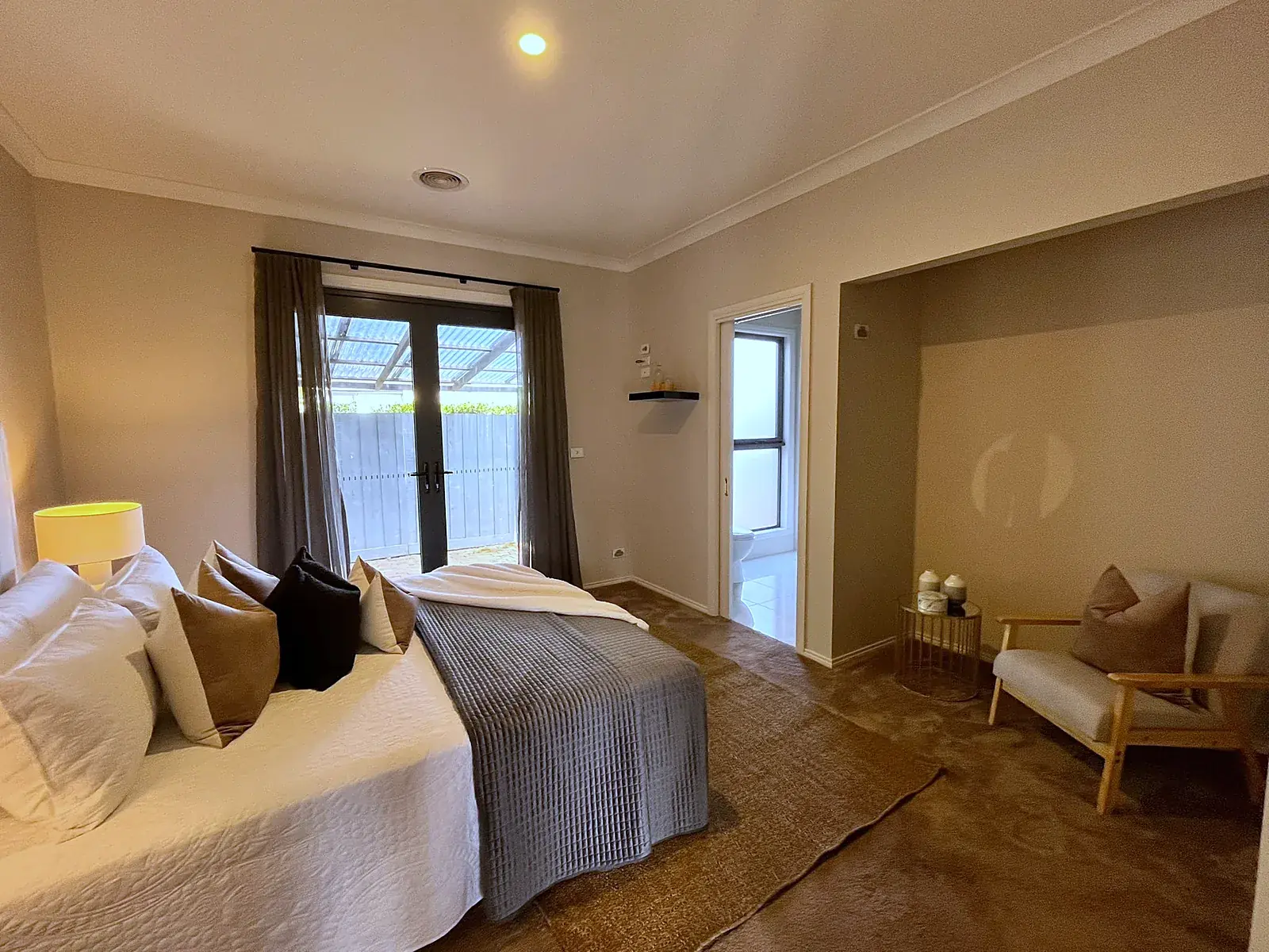 Master bedroom with sitting area staged in a Werribee home