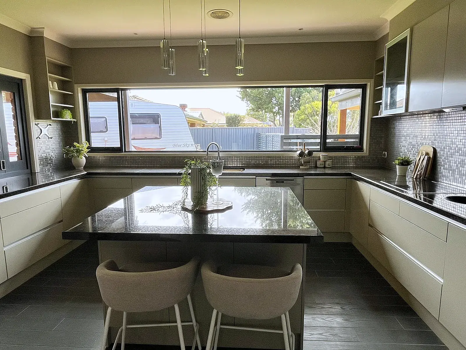 Kitchen with island bench styled with stools in a Werribee home