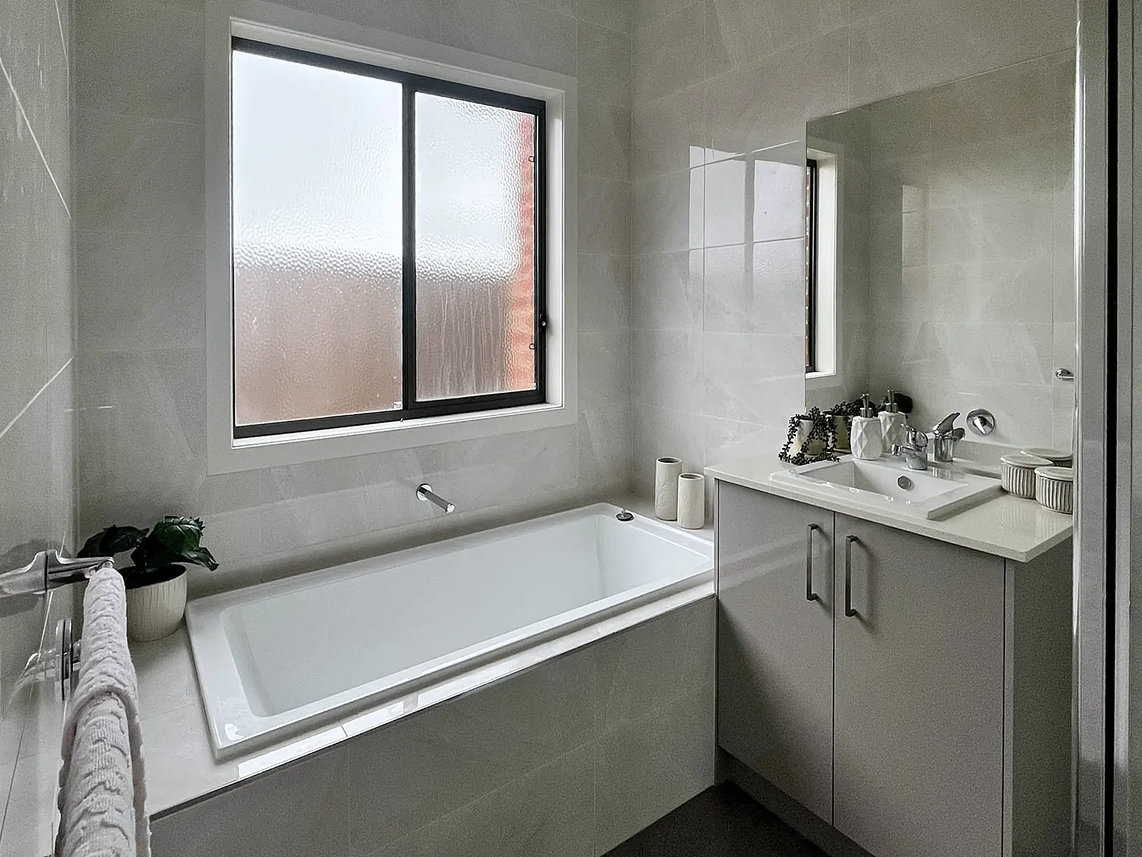 Bathroom styled with towels and greenery in a Wollert home