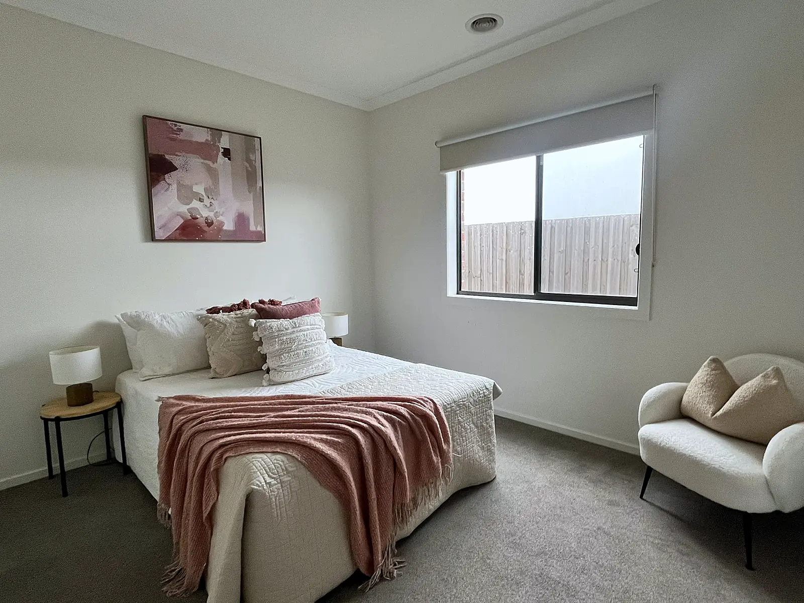 Bedroom styled with dusty pink throw and artwork in a Wollert home