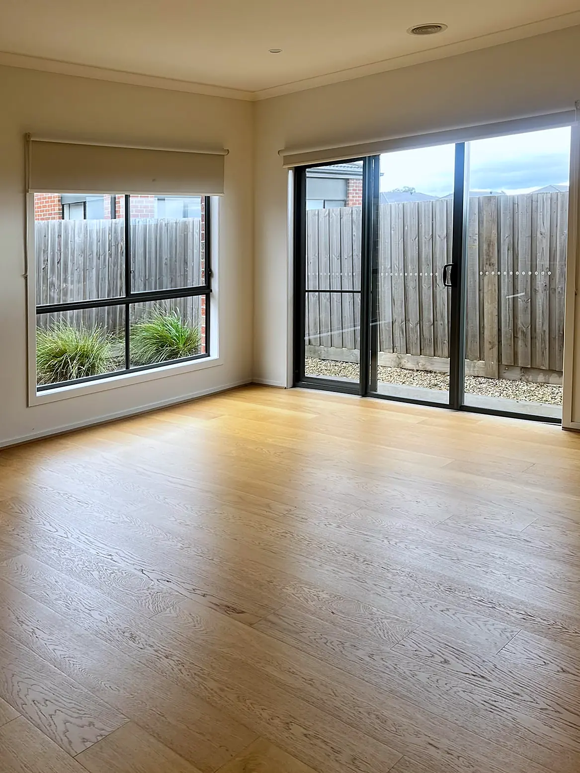 Empty living room with timber floor before staging in a Wollert home
