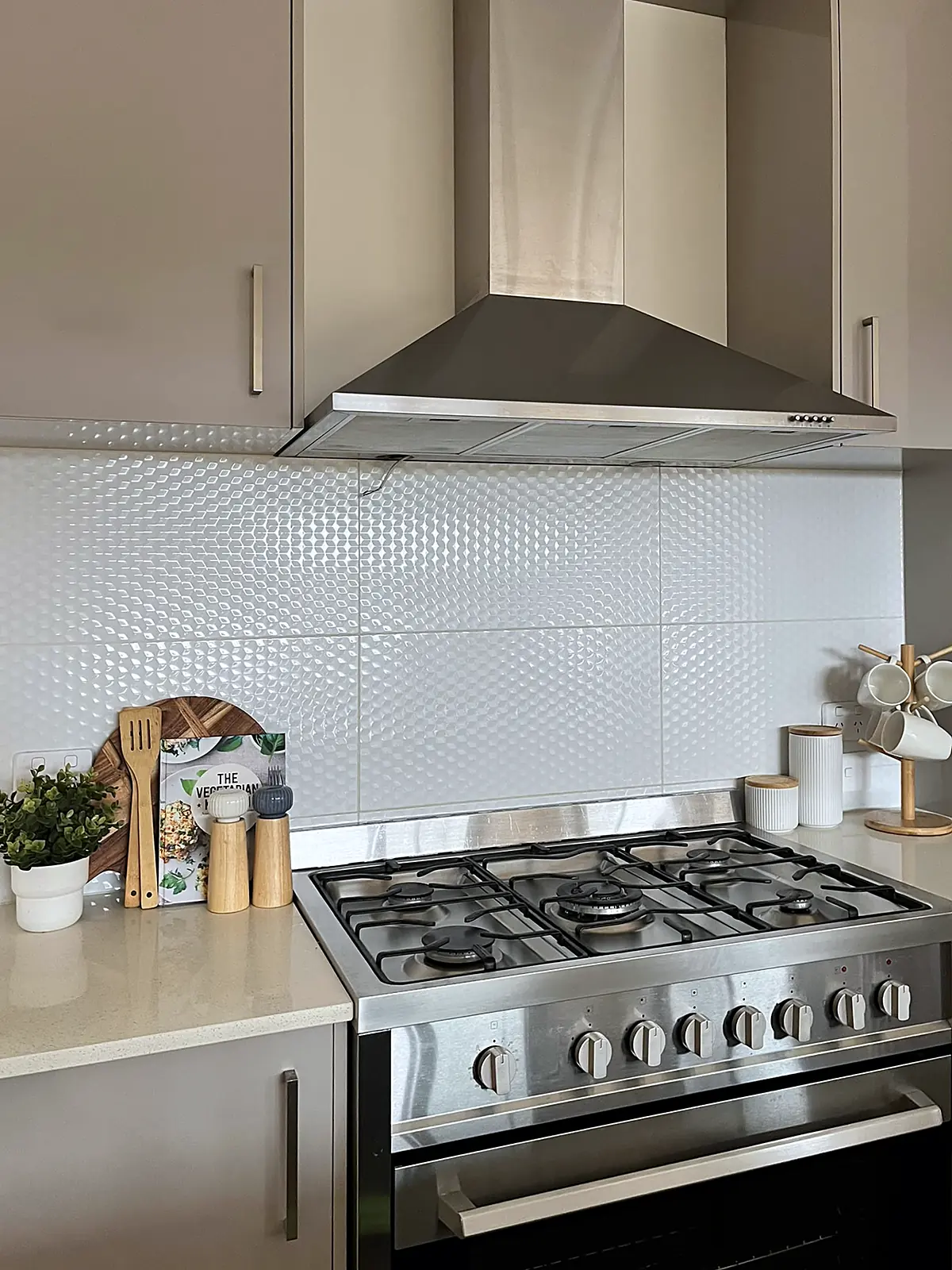 Kitchen styled with boards and greenery beside the cooker in a Wollert home