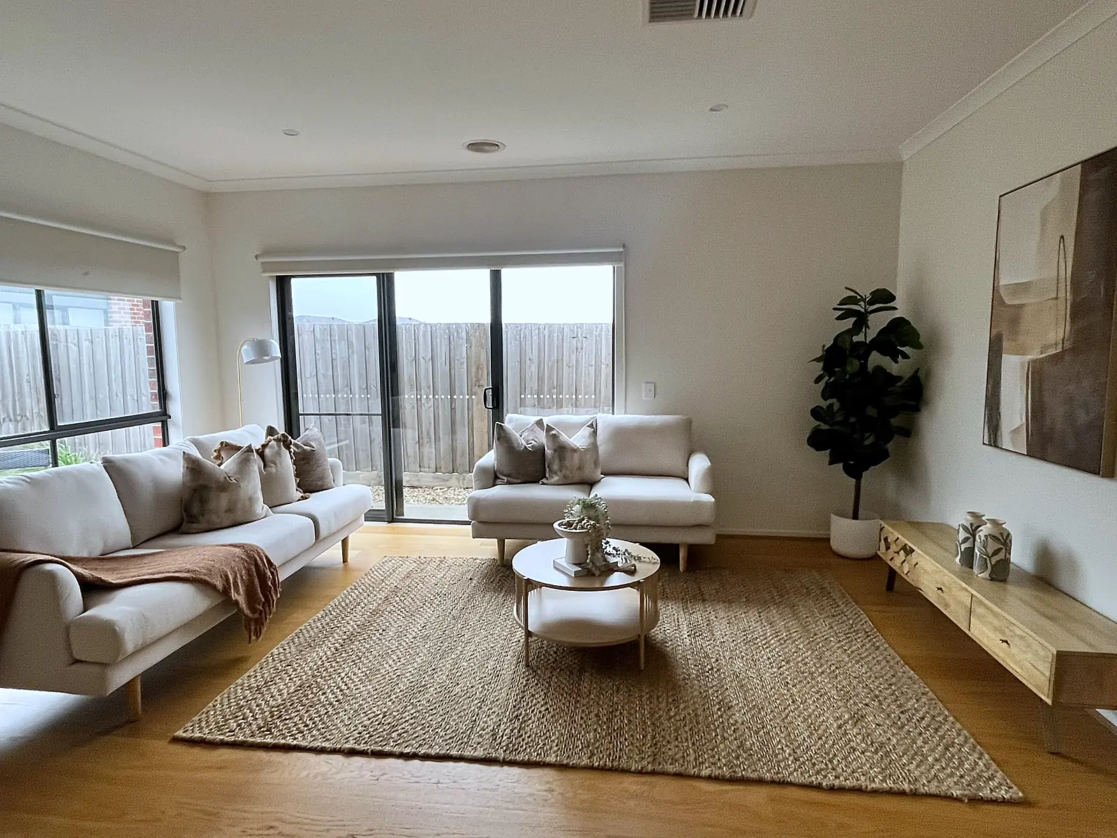 Staged living room with two sofas and round coffee table in a Wollert home
