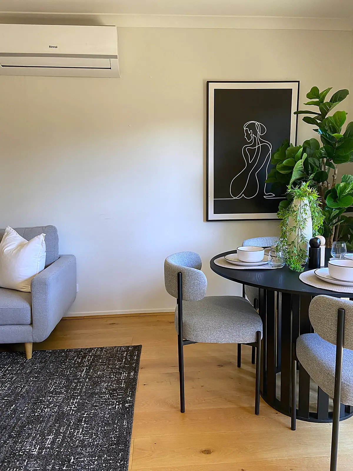 Round black dining table with boucle chairs in a staged Wyndham Vale home